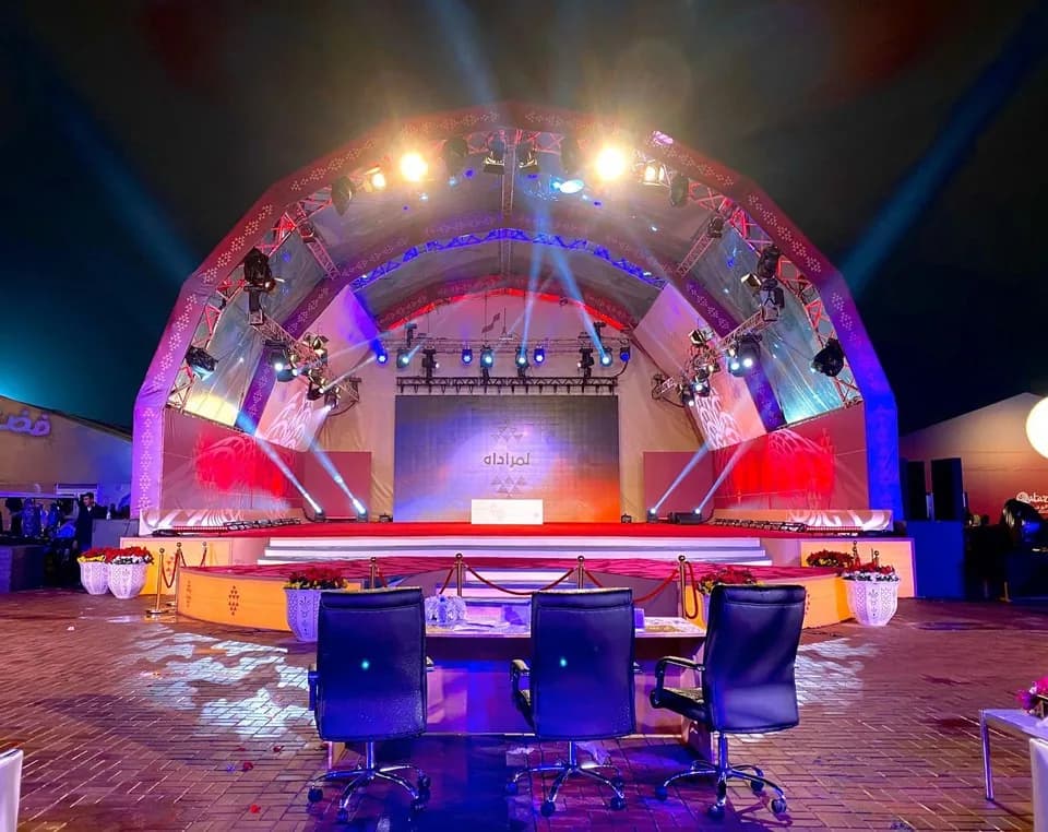 Large-scale outdoor concert stage production with lighting rig for a national celebration